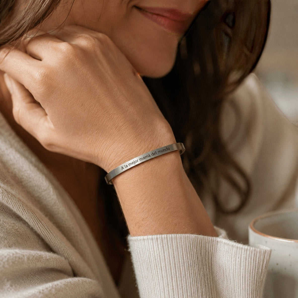 Brazalete esclava Moment de acero inoxidable personalizado con frase grabada en la muñeca de una mujer