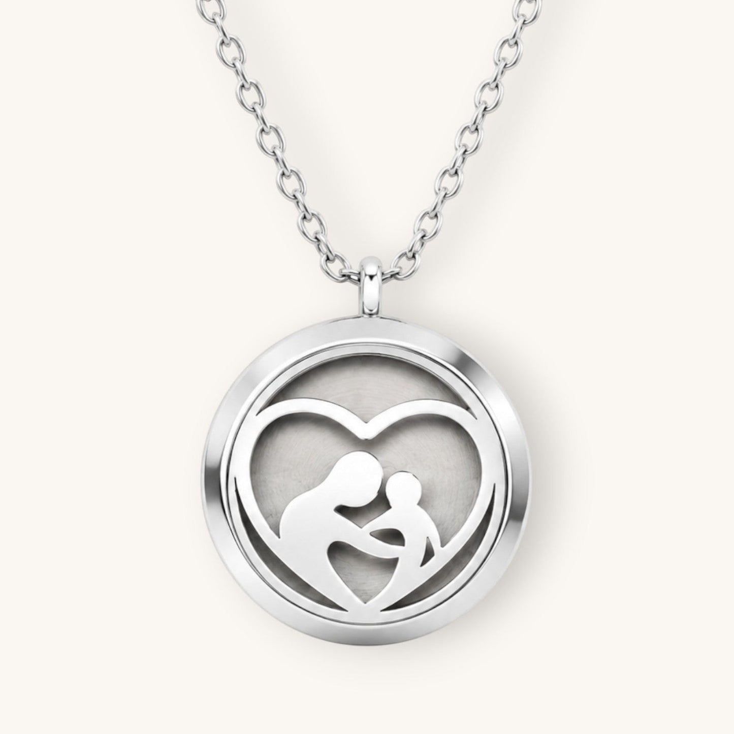 Collar Moment de acero inoxidable con medallón redondo plateado y diseño de corazón con silueta de madre e hijo